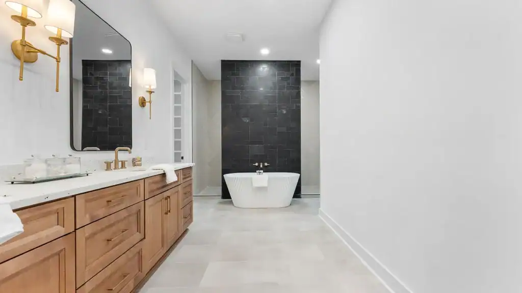 aaa83ceb65e9c18dcf5537aed483e47a-uncropped_scaled_within_1536_1152 Luxurious modern bathroom with freestanding bathtub, black accent wall, and elegant wooden vanity.