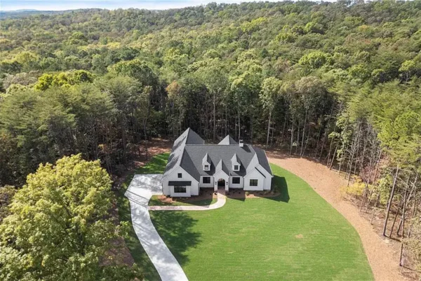 Modern custom home with spacious lawn and wooded privacy, designed by Bertamini Development.
