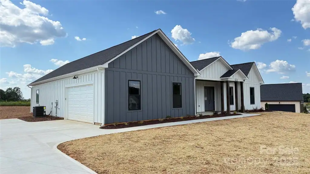 72352b1a4f597fcfb44cf217bf65c975-uncropped_scaled_within_1536_1152 Modern farmhouse home exterior with gray and white siding, new construction, and landscaped yard.