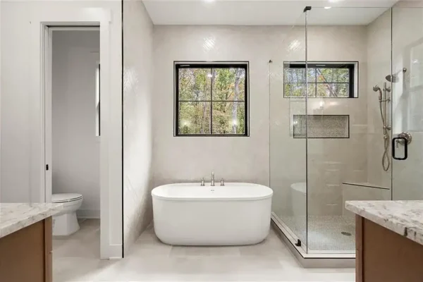 Modern luxury bathroom with freestanding tub and walk-in shower at Bertamini Development.