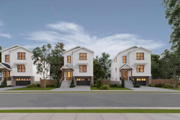 Modern white residential townhouses with landscaped front yards and stone accents.